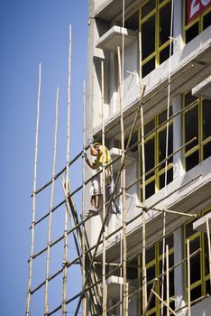 worker working at the construction side that are bamboo scaffolding