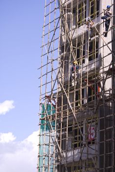 worker working at the construction side that are bamboo scaffolding