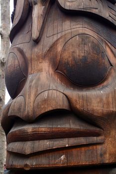 A close up of a Native American totem pole.