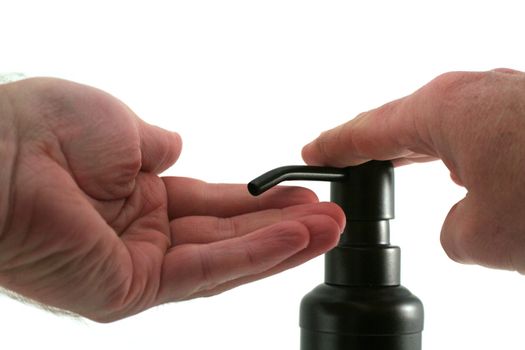 A hand soap dispenser being used, isolate on a white background.