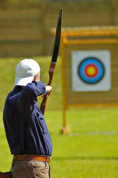 An archer aims for a target in the distance.