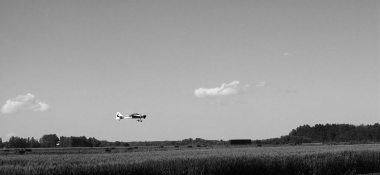 A small remote controlled plane landing in a field