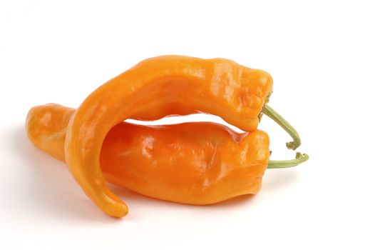 Orange peppers in a very suggestive position.