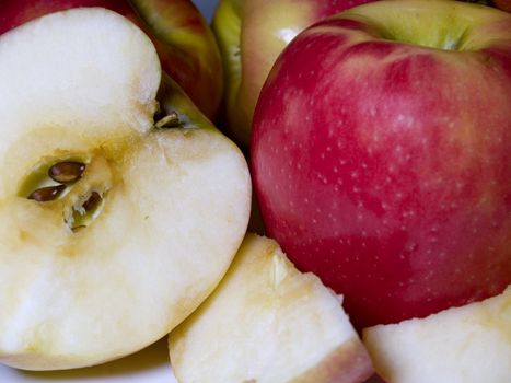 A group of green and red apples sliced in pieces and halves.