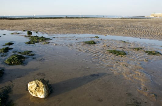 A view from Margate  beach in the late afternoon with a rock in the foreground