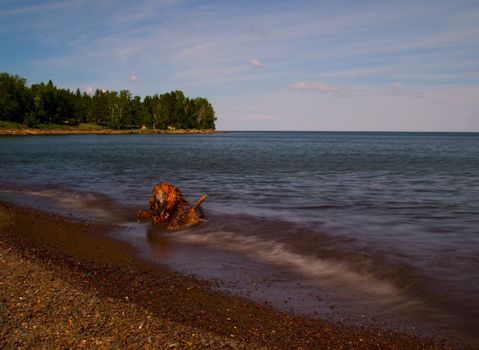 Flood Bay along the North shore of Lake Superior with driftwood and slow exposure.