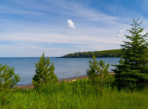 Flood Bay along the North shore of Lake Superior overlook through young evergreens.