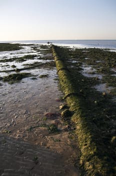 A view from Margate  beach in the late afternoon with a pipe in the foreground