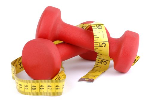 Red hand weights with tape measure on a white background.