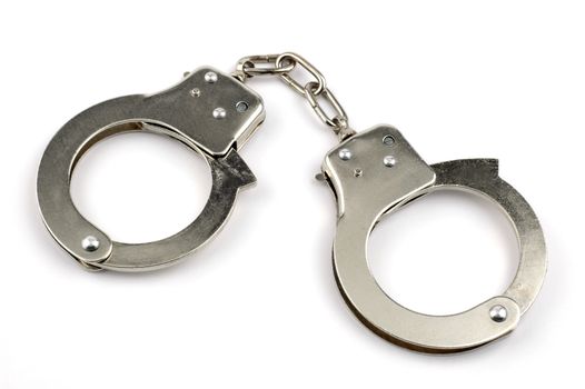 Pair of handcuffs isolated on a white background.