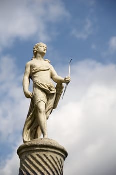 A stone statue with sky in the bckround