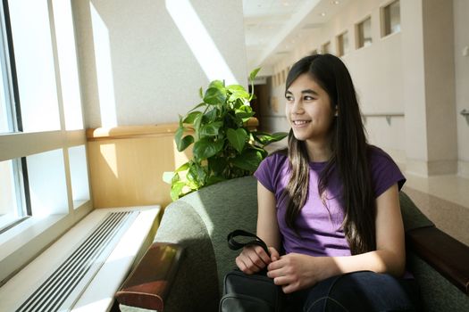 Young teen sitting in doctor's waiting room