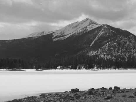 A winter image of a mountain over a frozen lake in Colorado.