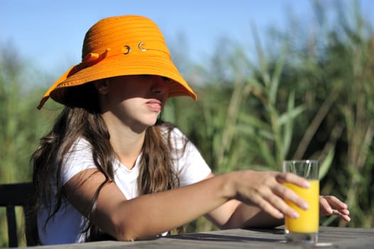 Woman drinking her juice during the summer holidays.