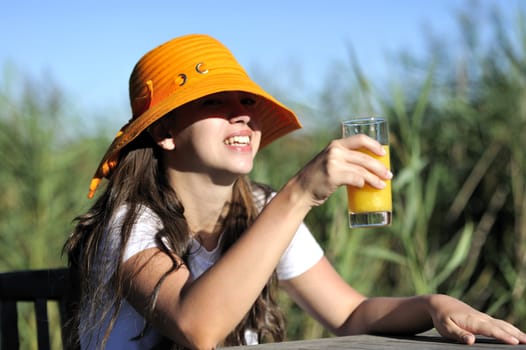 Woman drinking her juice during the summer holidays.