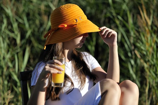 Woman drinking her juice during the summer holidays.