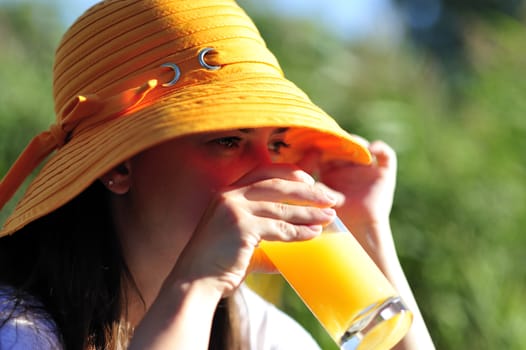 Woman drinking her juice during the summer holidays.