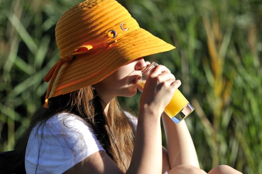 Woman drinking her juice during the summer holidays.