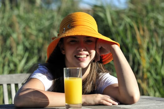 Woman drinking her juice during the summer holidays.