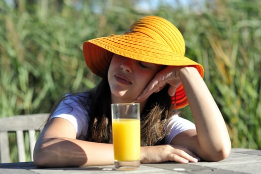 Woman drinking her juice during the summer holidays.