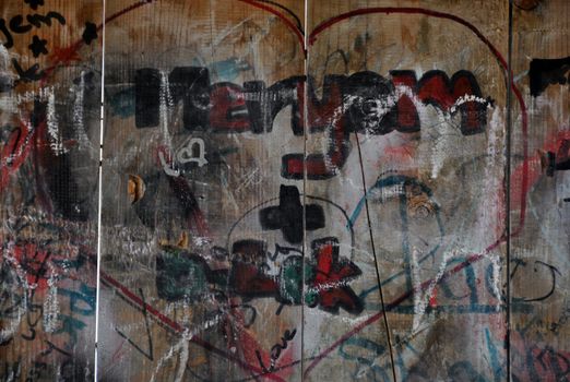 Colourful I love you scribbles written on wooden playground wall