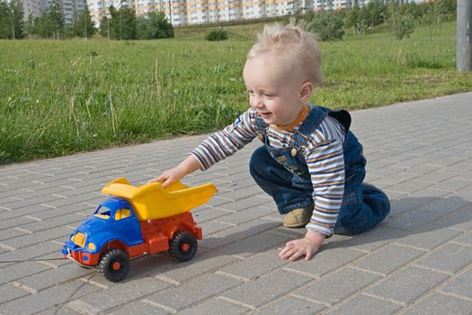 A child playing with a toy truck