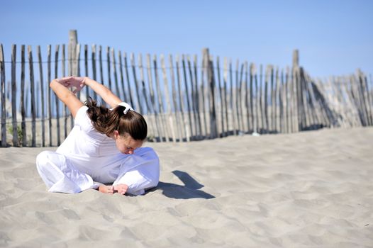 Woman doing stretching on the beach