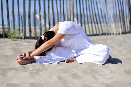 Woman doing stretching on the beach