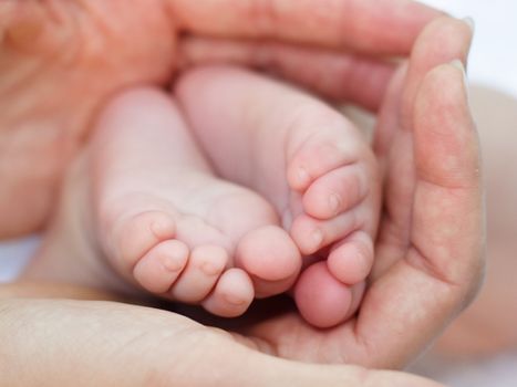 Mother holding her child's feet