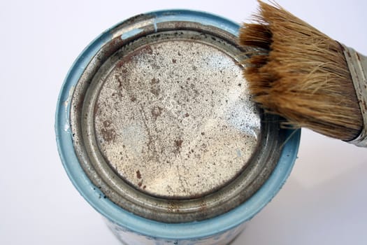 Paint can and brush after being used