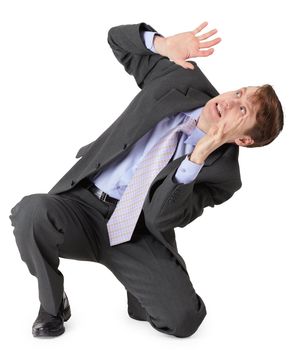 Very frightened businessman sitting on a white background