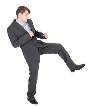 Young businessman kicks as karate, isolated on a white background