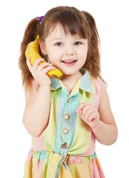 Child uses a banana as a mobile phone isolated on white