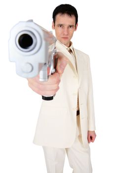 A man in a suit aims us in the face with a pistol