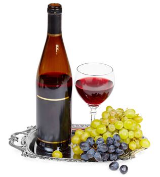 Beautiful still life - a bottle of wine, glass and grapes on a metal tray