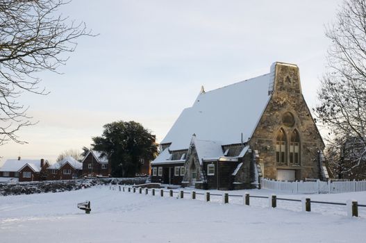 A church covered in snow in a rural setting