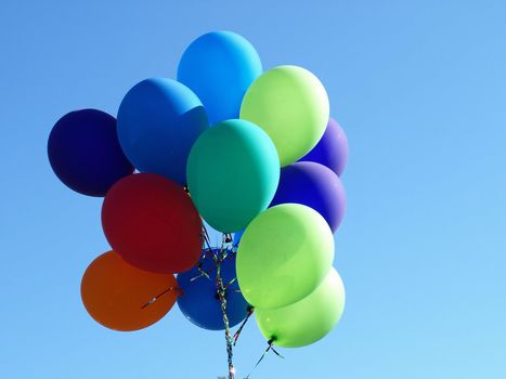 A colorful group of Balloons floating along the sky