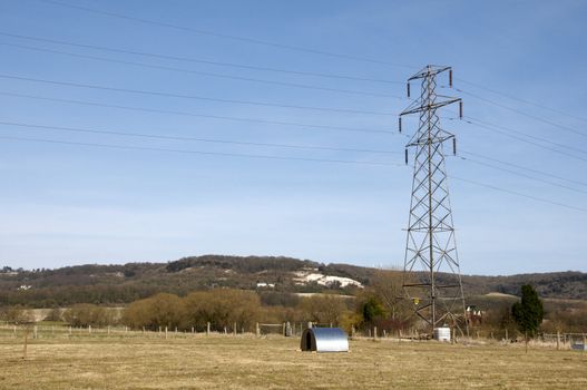 An electrical pylon in a field with a blue sky9