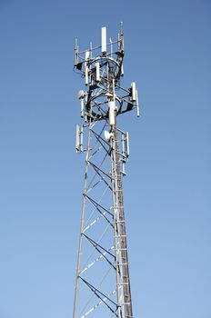 A phone mast against a clear blue sky