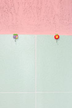 Pink stucco and green tiled wall. With hooks.