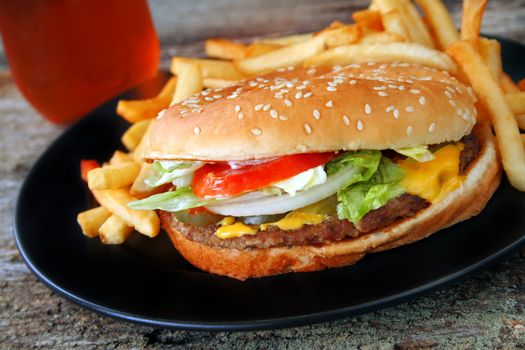 Cheeseburger with french fries and a drink.