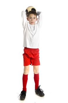 a boy in football uniform holding a football to throw