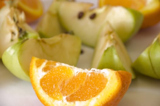 freshly cut organic fruits on light color background