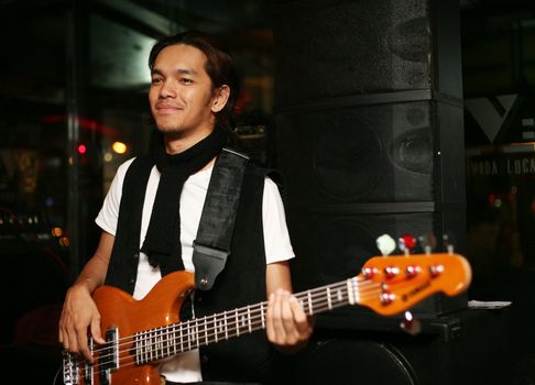 Young musician at an alive concert in a night club "La vida loka". Bali. Indonesia