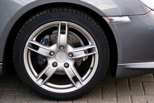 Closeup of the wheel of a very expansive car.