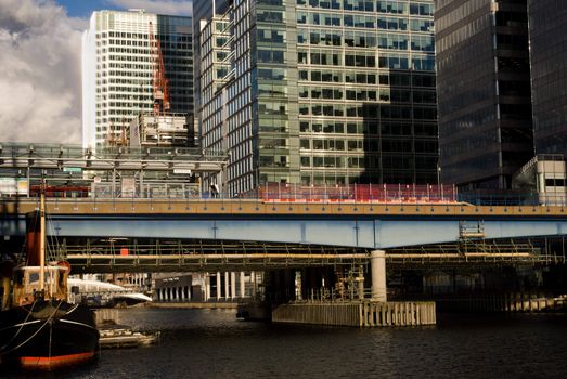 View of Canary Wharf station on the canal. London.