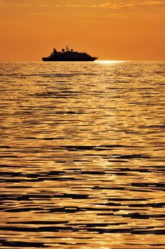 Boat silhouette on a quiet sea at twilight