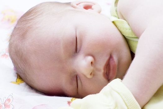 Baby asleep on the bed