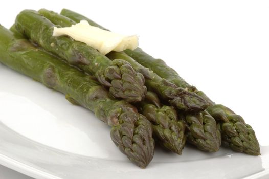 Fresh green steamed asparagus with a pat of butter.