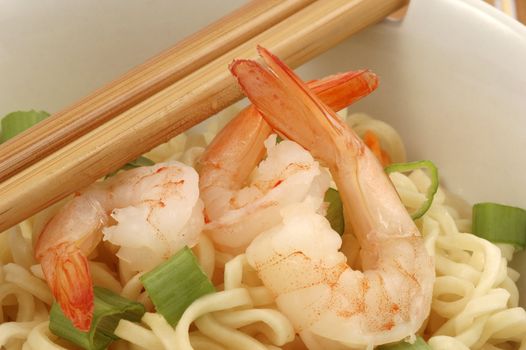 Bowl of oriental shrimp served with rice noodles.